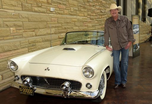 Alan Jackson poses beside his 1955 Ford Thunderbird at the opening of his Alan Jackson: 25 Years of Keepin It Country exhibit 